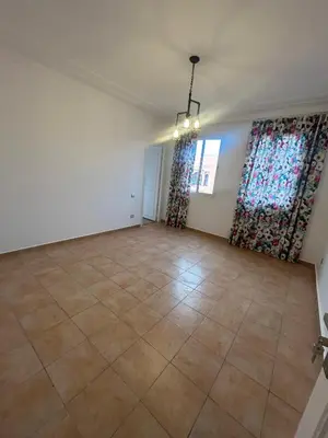 an empty living room with curtains and a tile floor at Appartement 3 Chambres 140 m Najd, Calme & Confort in Marrakech