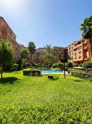 a park with a swimming pool and some buildings at Stylish Magnifique Duplex de Standing, 3 Chambres, Piscine, Proche de Gueliz in Marrakech