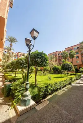 a street light in the middle of a park at Stylish Magnifique Duplex de Standing, 3 Chambres, Piscine, Proche de Gueliz in Marrakech