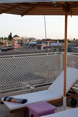 a white bench sitting on top of a roof at Dar Alma Modernist Designer Riad with Pool in Marrakech