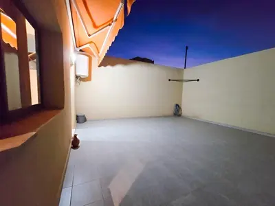 a large empty room with a view of a building at Burj Malak Duplex Villa Serenitas in Marrakech