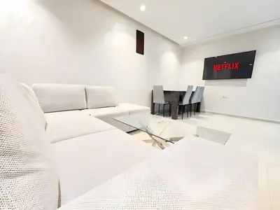 a living room with a couch and a table at Burj Malak Duplex Villa Serenitas in Marrakech