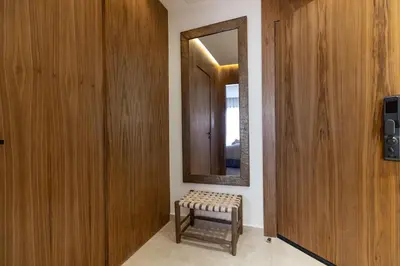 a bathroom with a mirror and a bench in a room at grand studio hypercentre de marrakech et proche gare in Marrakech