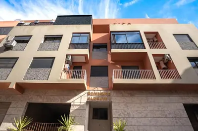 an exterior view of a building with balconies at Oasis Urban avec Balcon - 5min de l'aéroport in Marrakech