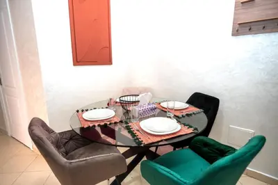 a dining room table with chairs and plates on it at Haven Cosy avec Piscine in Marrakech