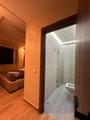 a room with a bathroom with a bed and a shower at Appartement luxueux avec piscine in Marrakech