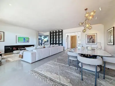 a living room with a white couch and a table at Ville d'Exception Marrakech in Marrakech