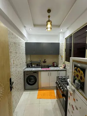 a kitchen with a stove and a washer and dryer at appartement airport Marrakech in Marrakech