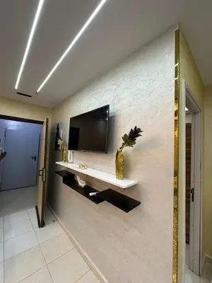 a living room with a television on a wall at appartement airport Marrakech in Marrakech