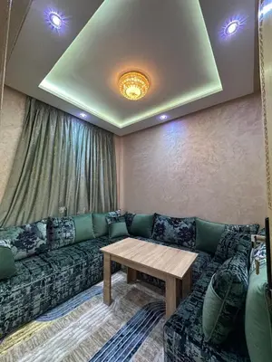 a living room with a couch and a table at appartement airport Marrakech in Marrakech