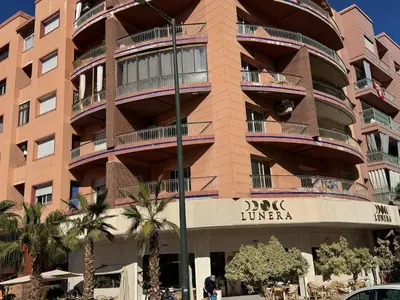 a building with a sign on the side of it at appartement de luxe dans le centre de marrakech in Marrakech