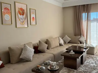 a living room with a couch and a table at appartement de luxe dans le centre de marrakech in Marrakech