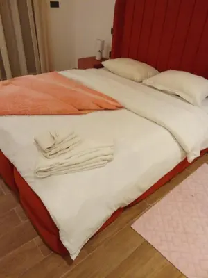 a bed with two towels on top of it at Elegant 2 bedroom apartment in Palmeraie Gates in Marrakech