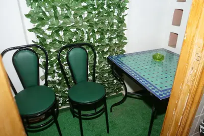 a table and four chairs next to a table and a table and chairsuggest at Calm Spacious Family Apartment Close To Coty in Marrakech