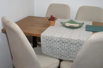 a dining room table with chairs and a green plate on it at Calm Spacious Family Apartment Close To Coty in Marrakech