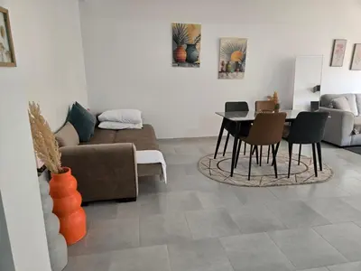 a living room with a couch and a table and chairs at luxury apartment in Marrakech center in Marrakech