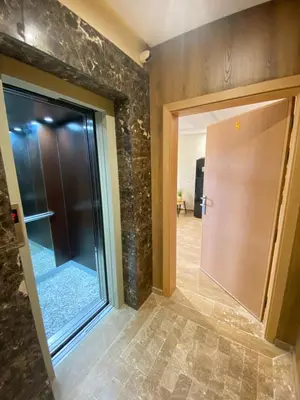 a hallway with a glass door and a tile floor at Small Cosy & Balcon & Vue Palmier et Montagne in Marrakech