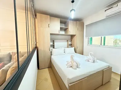 a bedroom with a bed with two white towels at Marrakech-Central studio in Guéliz - WiFi, Netflix in Marrakech