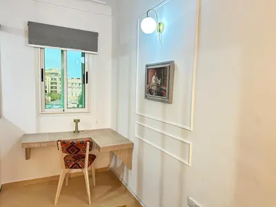 a bathroom with a wooden desk and a window at Marrakech-Central studio in Guéliz - WiFi, Netflix in Marrakech