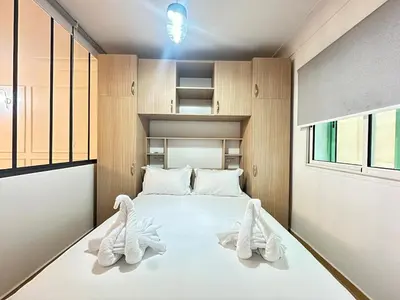 a bedroom with a large white bed with towels on it at Marrakech-Central studio in Guéliz - WiFi, Netflix in Marrakech