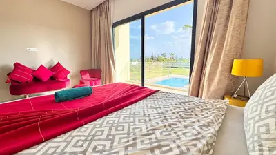 a bedroom with a large bed and a large window at New Villa Dali & Spa Paddel Marrakech in Marrakech