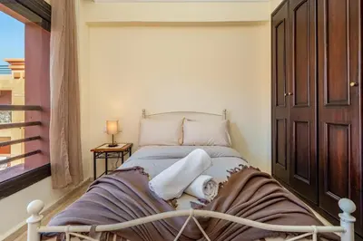 a bedroom with a bed with towels on it at Cocon Ocre Pool and Balcony in Marrakech