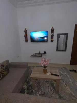 a living room with a couch and a tv on the wall at appartement lady Plaza 2 in Marrakech