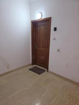 an empty room with a wooden door and a light at appartement lady Plaza 2 in Marrakech