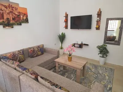a living room with a couch and a table at appartement lady Plaza 2 in Marrakech