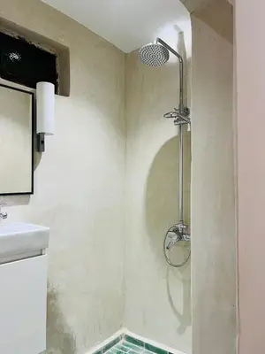 a shower in the corner of a bathroom at Riad Dar L artiste in Marrakech