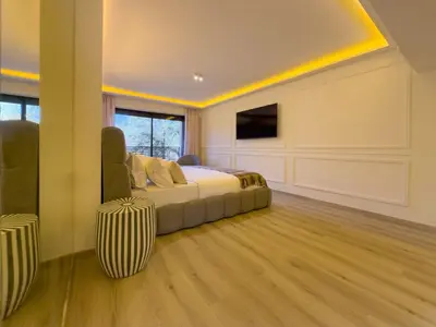 a large bedroom with a bed and a tv at JARDIN VITTORIO - Marrakech - Hivernage - Heated & Luxury Pool in Marrakech