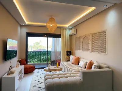 a living room with a couch and a large window at Majorelle Luxury Studio in Marrakech