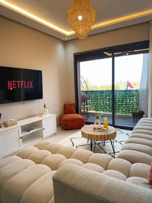 a living room with a couch and a tv at Majorelle Luxury Studio in Marrakech