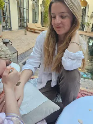 a woman is talking to a young girl at Daba Village in Marrakech