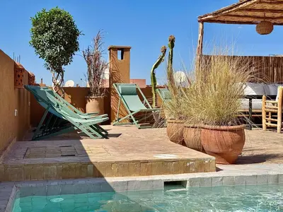 a patio with chairs and a swimming pool at Maison Remedy et Spa Private Pool & Breakfast in Marrakech