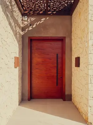 a wooden door in a room with a brick wall at LA VILLA 58 - Ecolodge - Marrakech in Marrakech