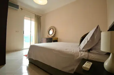 a bedroom with a large bed and a mirror at Dar Aicha in Marrakech