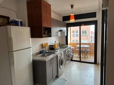 a kitchen with a white refrigerator and a sink at Nour in Marrakech