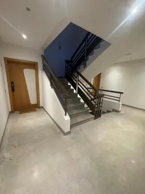 an empty room with stairs and a blue wall at Appartement moderne avec terrasse vue piscine in Marrakech