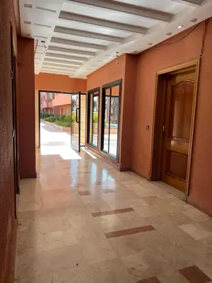 an empty hallway of a building with a door at Appartement spacieux 1min Menara Mall 5mins de gare ferroviaire in Marrakech