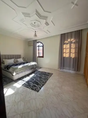 a large bedroom with a bed and a window at Villa Familiale in Marrakech