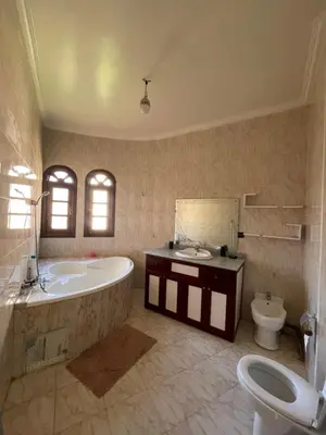a bathroom with a tub and a toilet and a sink at Villa Familiale in Marrakech