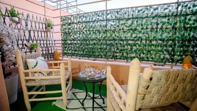 a room with chairs and a table and a window at le 26M in Marrakech