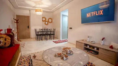 a living room with a netflix sign on the wall at le 26M in Marrakech