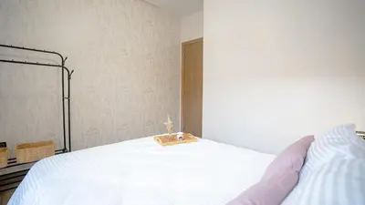 a person laying on a bed with a wooden tray on it at le 26M in Marrakech