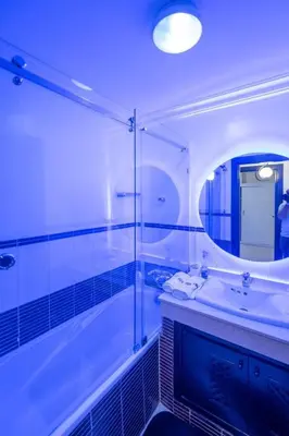 a bathroom with a tub and a sink and a mirror at Calm Apartment with Pool in Geuliz marrakech Close to Medina in Marrakech
