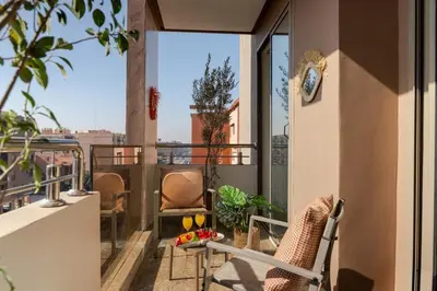 a balcony with chairs and a view of the city at Lalla Homes 369 in Marrakech