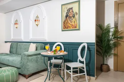 a living room with a couch and a table and chairs at Lalla Homes 369 in Marrakech