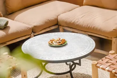 a bowl of food on a table in front of a couch at 3BR Gueliz , Rooftop Heated Pool , 10 min Jamaa el Fna, in Marrakech