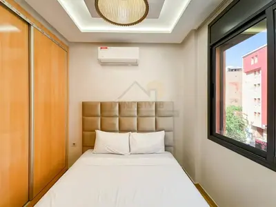 a small bedroom with a bed and a window at Appartement de charme au cœur de la ville rouge in Marrakech